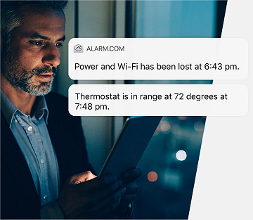 Man receiving a loss of power alert on his tablet